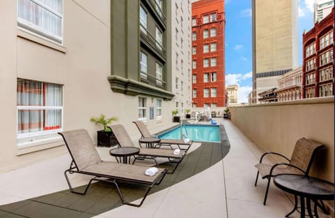 Unwind poolside on sun loungers in the city air.
