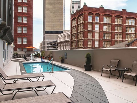 Lounge with a book while the pool sparkles nearby.