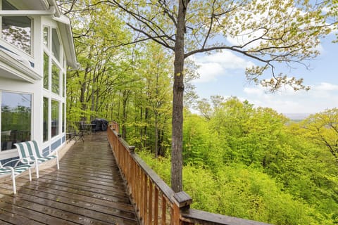 Sun-drenched and serene, this corner of the large porch offers a cozy nook to sit back and unwind amidst lush surroundings.