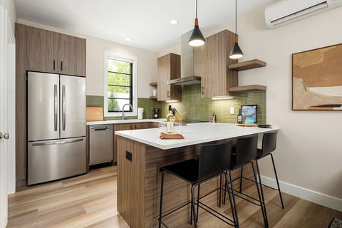 Cook with ease in this stylish kitchen featuring modern appliances and warm wood cabinetry.