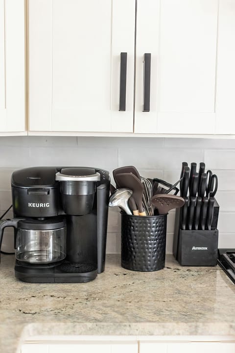 Keurig coffeemaker and kitchen cooking utensils.