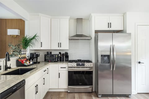 The kitchen is fully stocked with updated appliances and cookware.