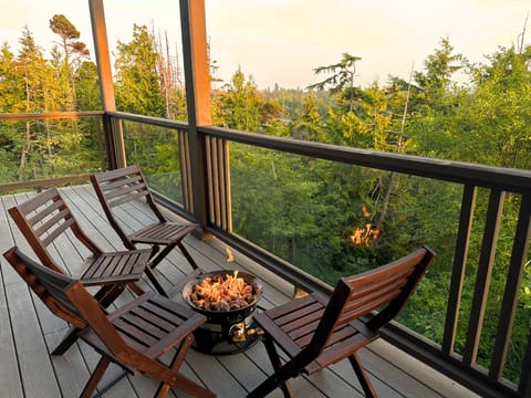 Propane fire pit with a view of the rainforest and ocean. Fire-ban friendly.