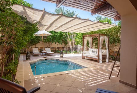 Linger poolside under cooling shade sails and daybeds.