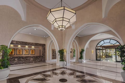 Step into an elegant lobby with airy arches and calm light.