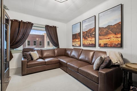 Sink into this luxurious leather sectional while beautiful desert landscape art sets a serene mood for your perfect getaway.