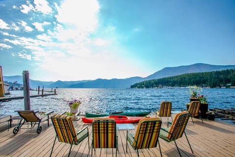 Stunning Lakeside Retreat. Welco to your perfect getaway! This beautiful vacation rental offers breathtaking views of the serene lake surrounded by majestic mountains.
Outdoor Space: Relax in lounge chairs on a spacious deck.
