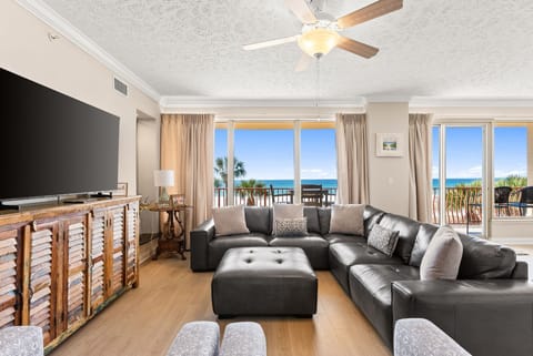 Relax in this modern living room with ocean views and balcony access.