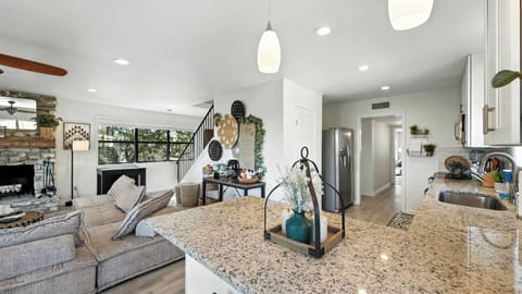 Ample countertops and open sightlines keep the kitchen connected to the living room — prep meals without missing the fun.