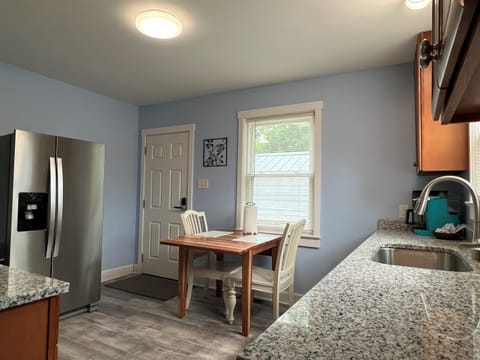 Kitchen with side by side fridge and freezer, back door to patio.