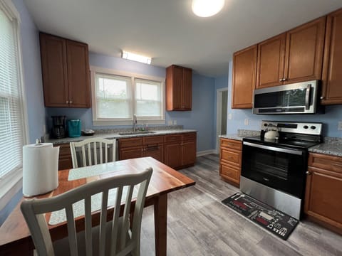 Full kitchen with stove, microwave, large sink.