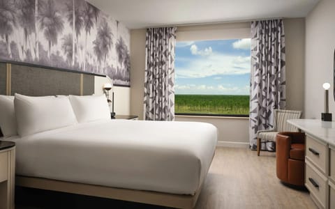 Unwind in crisp linens with peaceful views beyond the window.