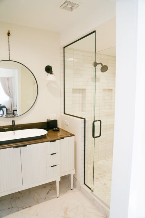 Start your day in a sleek bath with glass walk-in shower.