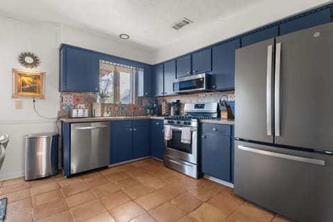 A vibrant patterned tile backsplash in the adjacent kitchen.
