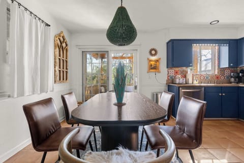 The mix of leather chairs and a wishbone-style armchair with faux fur creates a uniquely stylish and comfortable setting for your meals.