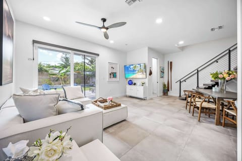 Modern living room with large sliding doors opening to a private outdoor space.