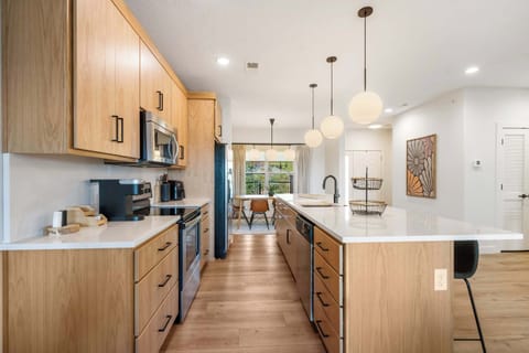 The chic, open kitchen offers ample space & every home comfort