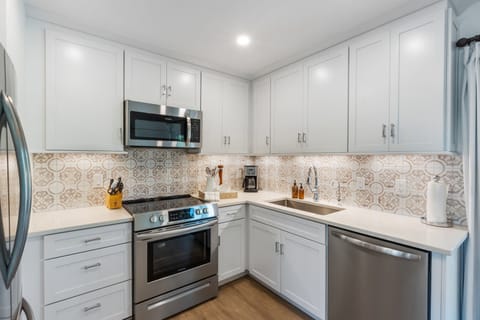 Fully stocked kitchen w/ stainless appliances, coffee maker, & filtered water.