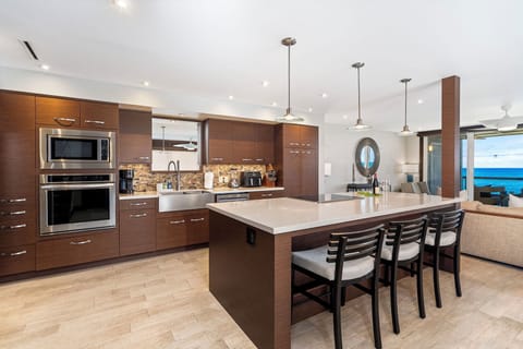 Gourmet Kitchen Equipped with Stainless Steel Appliances and Large Island