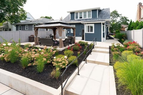 Rear walkway with vibrant landscaping and secure, fenced access to your guest suite entrance.