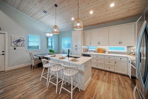 Fully equipped kitchen with barstool seating.