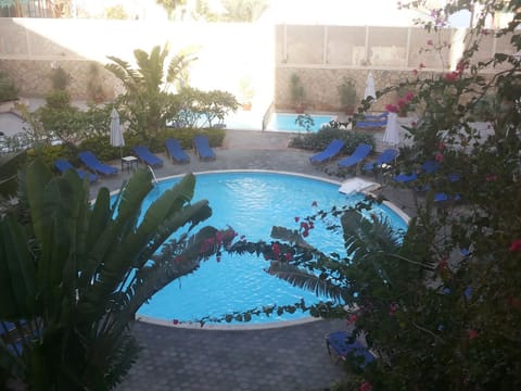 Relax in dappled shade while the pool shimmers below.
