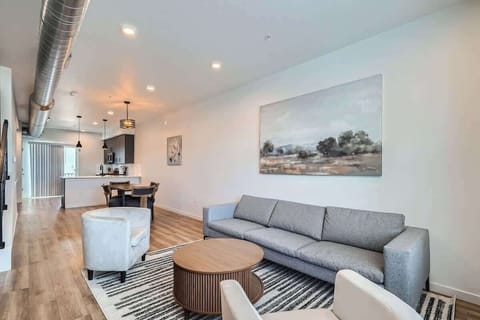 Open-concept living area connecting to kitchen and dining space