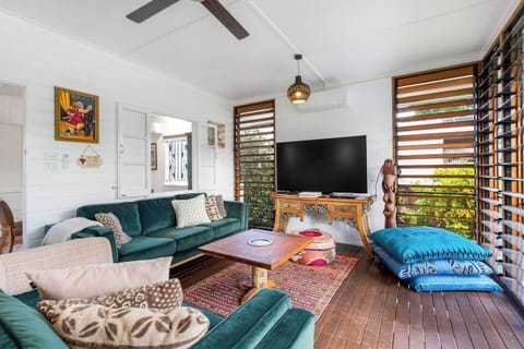 Settle into the vibrant living area where velvet seating, cultural artwork and vintage details create a character-rich zone for relaxing or movie nights.