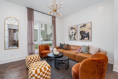 Bright open floor living space featuring designer furnishings and a smart flat-screen TV. (2nd Floor)