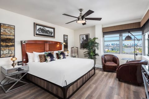 Unwind in a stylish king bed with bright city views.