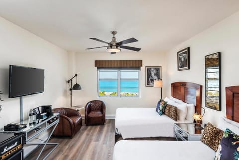 Step into a bright coastal bedroom with sweeping sea views.