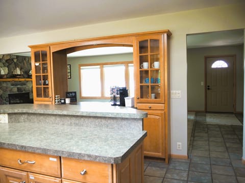 Kitchen, view into living room & back door