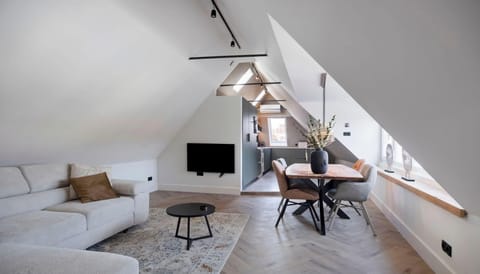 Spacious and bright penthouse living area with neutral tones, custom sofa setup and modern styling.