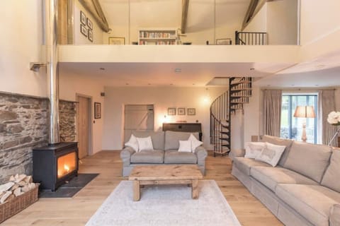 Main living room showing gallery above, large woodburner.