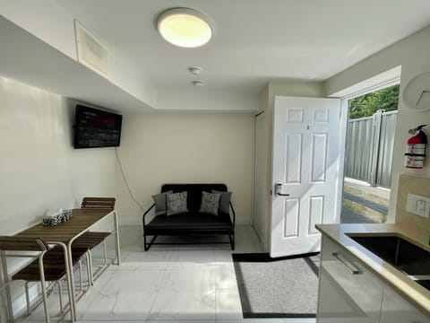 Living Room with Sofa-bed, dining table, with 2 chairs and 2 stools.