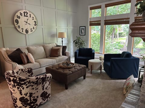Main floor living space, lots of seating, fireplace & view of secluded back yard