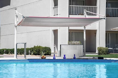 Cool off in sparkling water with shaded poolside comfort.