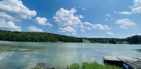 Savor stunning lake views from the porch, luxurious hot tub, cozy firepit, or manicured lawn. Enjoy the ideal backdrop for relaxation and unforgettable moments.