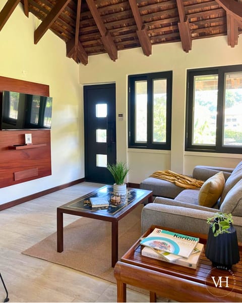 Spacious living area with bright windows, Smart TV, comfy seating, and board games. 