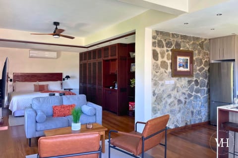 Spacious living area with large bright windows, Smart TV, comfy seating, and board games. 