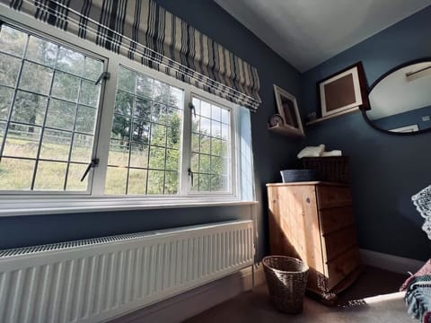 Bedroom three is a small double with an ensuite shower room. Views to the woodlands behind are a perfect start to a lazy morning! Watch out for the beautiful white horse that grazes in the field at the fence.
