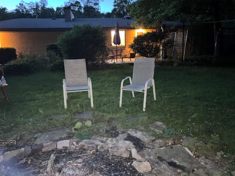 Backyard fire pit steps from the patio and overlooking the creek.