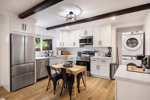 Cabinets, wood floors, and high-end finishes make this kitchen a perfect area for cooking and enjoying the meals.