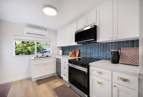 Black stainless against white cabinetry—this kitchen’s blue-tiled backsplash make the kitchen special.