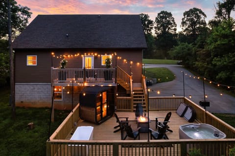 Unwind on the deck with a fire pit, hot tub, and string lights under the stars!