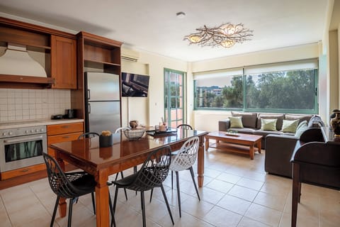 omfortable open plan living room with a fully equipped kitchen.