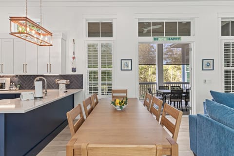 Gather your group around this spacious dining table, where the open kitchen invites conversation and the balcony beckons for morning coffee.