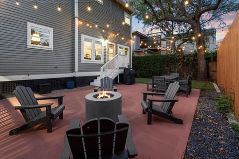 Outdoor patio with fire pit, lounge seating, and string lights – perfect for relaxing evenings in Galveston vacation rental