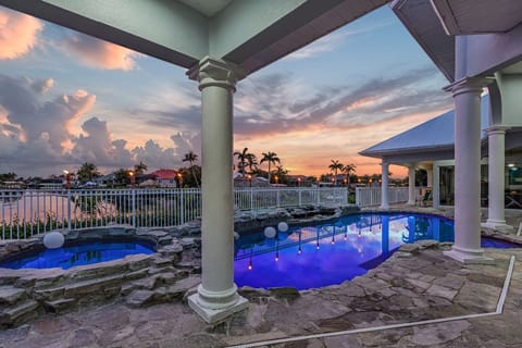 Sunset from pool deck overlooking  pool and hot tub..