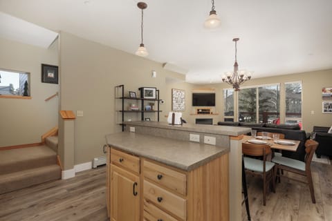 Unwind in your open-concept living space where natural light streams through large windows, perfect for relaxing after mountain adventures.